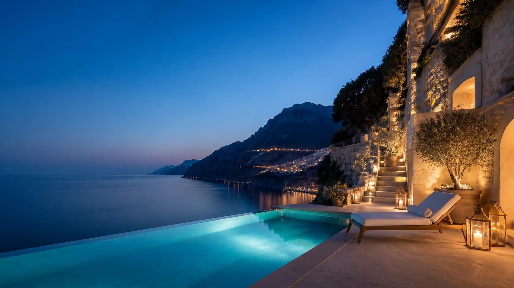An infinity pool terrace above the sea at dusk